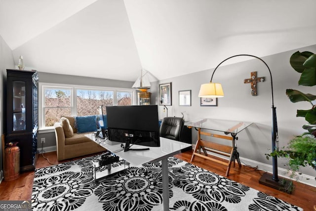 living area with lofted ceiling, wood finished floors, and baseboards