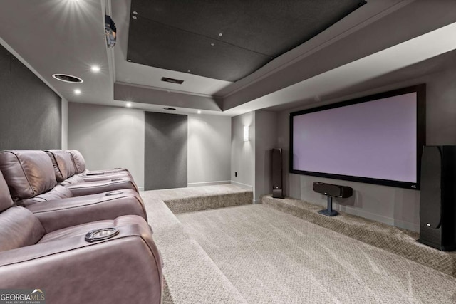 home theater room featuring recessed lighting, a raised ceiling, baseboards, and carpet floors