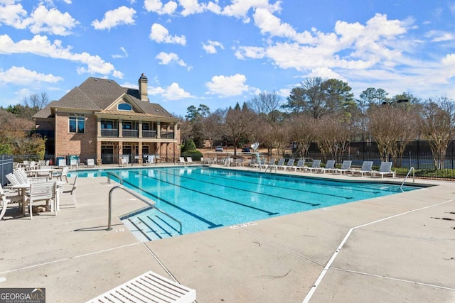 pool with fence and a patio area