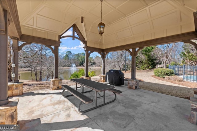 view of patio featuring a grill and fence