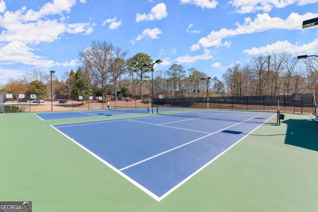 view of sport court featuring fence