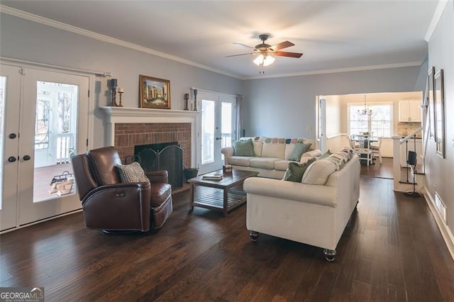 living area featuring dark wood-style floors, a wealth of natural light, french doors, and a brick fireplace