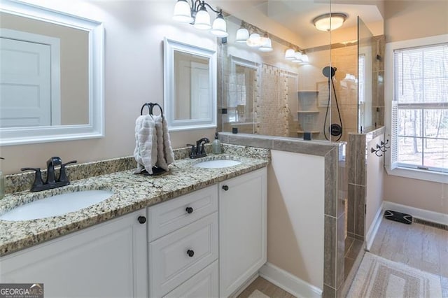 bathroom featuring double vanity, a sink, and a wealth of natural light