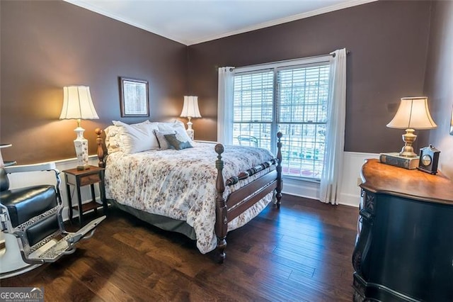 bedroom featuring crown molding, dark wood-type flooring, and wainscoting