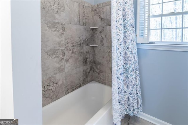 full bathroom featuring baseboards and shower / bath combination with curtain