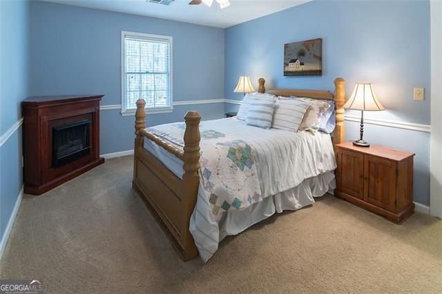 bedroom featuring carpet flooring, a fireplace, and baseboards