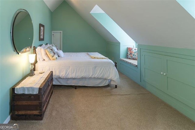 carpeted bedroom with lofted ceiling with skylight