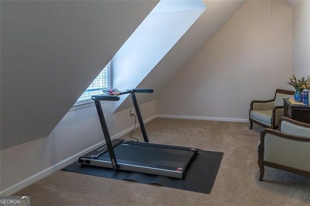 workout area with vaulted ceiling, carpet flooring, and baseboards