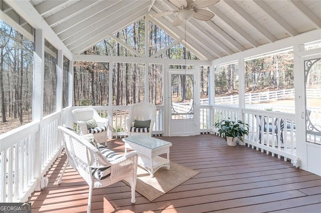 sunroom / solarium with vaulted ceiling with beams, a wealth of natural light, and ceiling fan