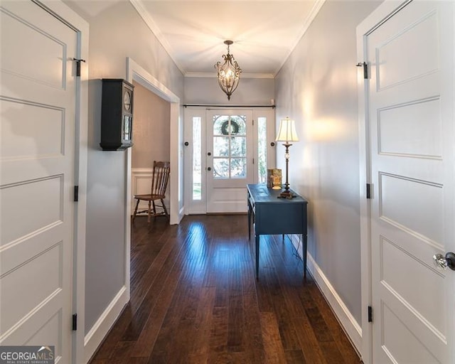 entryway with a chandelier, dark wood-style flooring, baseboards, and crown molding