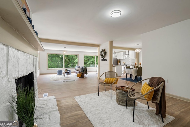 5985 Lakeside Ct, Gainesville, GA 30506 - living area with light wood-type flooring, a fireplace, and baseboards
