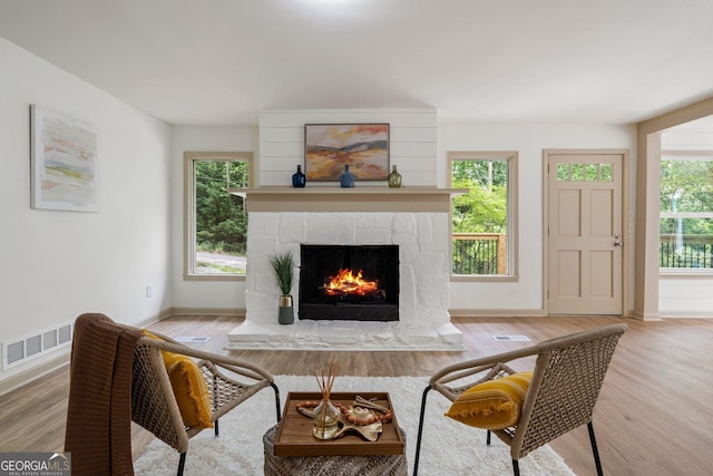 5985 Lakeside Ct, Gainesville, GA 30506 - living area with a stone fireplace, wood finished floors, and baseboards