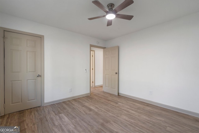 5985 Lakeside Ct, Gainesville, GA 30506 - unfurnished bedroom with baseboards, wood finished floors, and ceiling fan