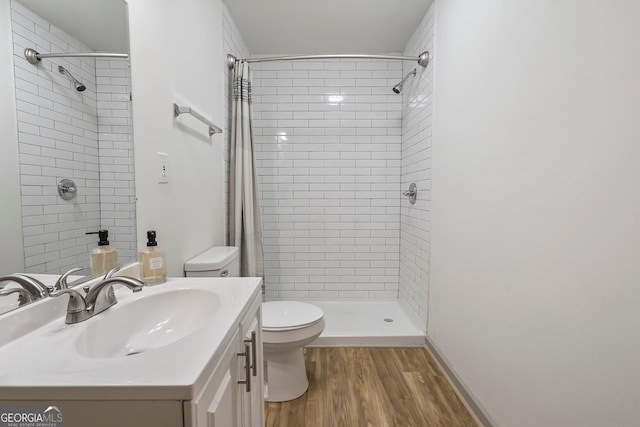 5985 Lakeside Ct, Gainesville, GA 30506 - bathroom with toilet, vanity, a tile shower, and wood finished floors
