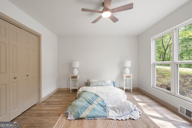 5985 Lakeside Ct, Gainesville, GA 30506 - bedroom with light wood finished floors, baseboards, a ceiling fan, and a closet