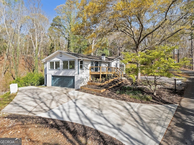 5985 Lakeside Ct, Gainesville, GA 30506 - view of front of property featuring concrete driveway, a deck, a garage, and a chimney