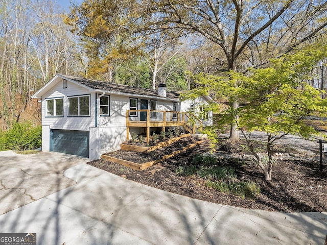 5985 Lakeside Ct, Gainesville, GA 30506 - view of front of home featuring driveway, a wooden deck, a garage, and a chimney