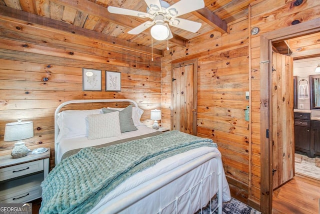 bedroom with wood ceiling, wood walls, beam ceiling, and wood finished floors