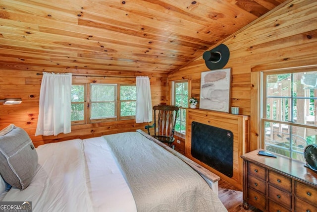 bedroom with lofted ceiling, wood walls, wood finished floors, and wood ceiling