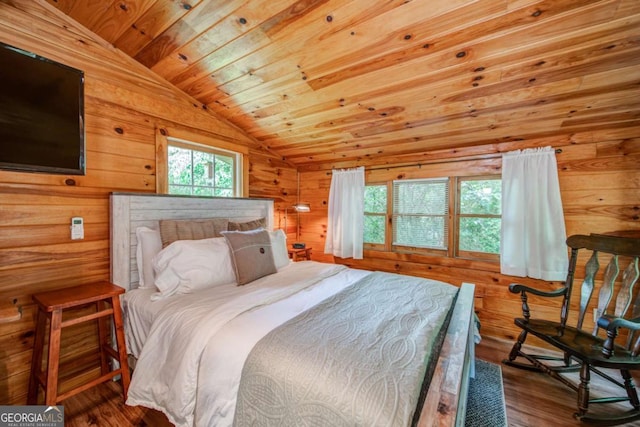 bedroom featuring vaulted ceiling, wood finished floors, wood ceiling, and wooden walls