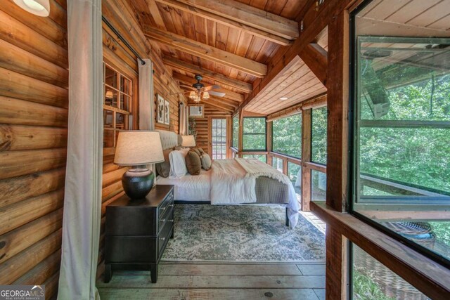 unfurnished bedroom featuring rustic walls, wooden ceiling, wood-type flooring, and vaulted ceiling with beams