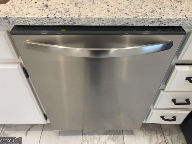 interior details with white cabinets and stainless steel dishwasher