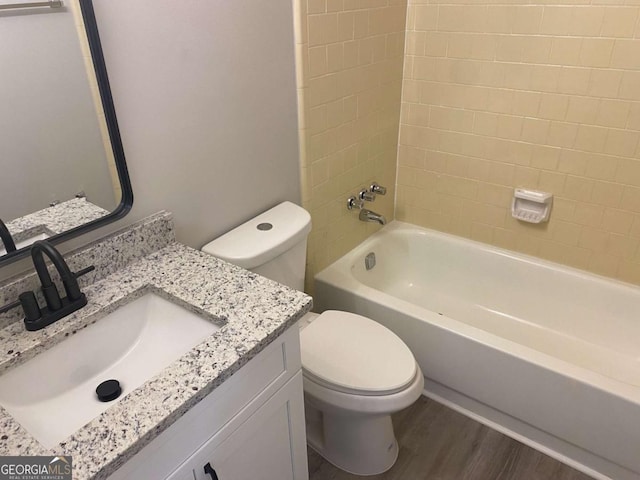 bathroom with shower / bath combination, vanity, toilet, and wood finished floors