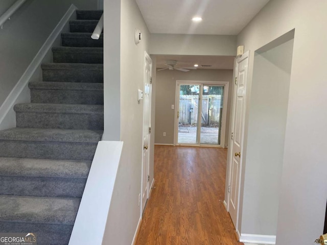 stairway featuring recessed lighting, ceiling fan, baseboards, and wood finished floors