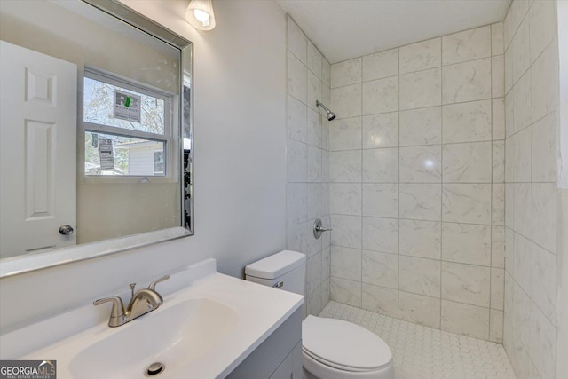 full bath featuring vanity, toilet, and a shower stall