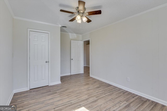 unfurnished bedroom featuring ornamental molding, visible vents, and light wood finished floors