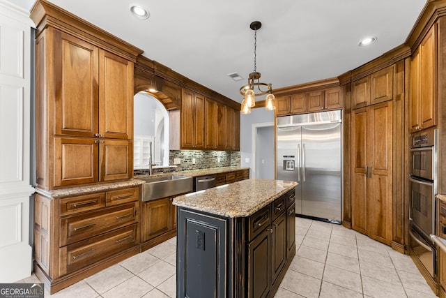 1348 Ewing Creek Dr, Dacula, GA 30019 - kitchen with appliances with stainless steel finishes, light tile patterned floors, backsplash, brown cabinets, and recessed lighting