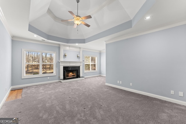 1348 Ewing Creek Dr, Dacula, GA 30019 - unfurnished living room with ornamental molding, a ceiling fan, healthy amount of natural light, a raised ceiling, and carpet flooring