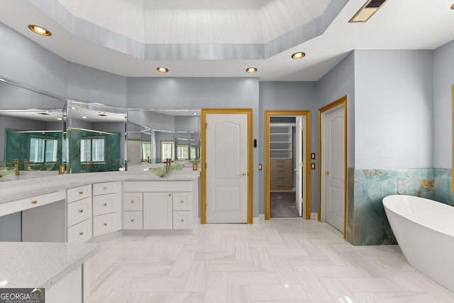 1348 Ewing Creek Dr, Dacula, GA 30019 - full bathroom featuring a soaking tub, vanity, recessed lighting, a closet, and wainscoting