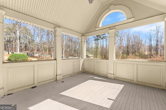 1348 Ewing Creek Dr, Dacula, GA 30019 - unfurnished sunroom with lofted ceiling and view of scattered trees