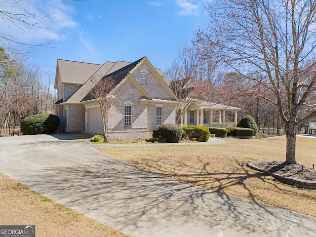 1348 Ewing Creek Dr, Dacula, GA 30019 - view of front of house featuring brick siding, driveway, an attached garage, and a front yard