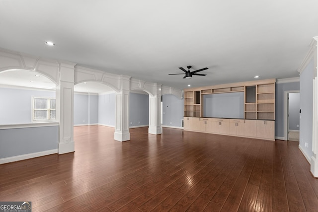 1348 Ewing Creek Dr, Dacula, GA 30019 - unfurnished living room with ceiling fan, arched walkways, dark wood-style floors, recessed lighting, and crown molding