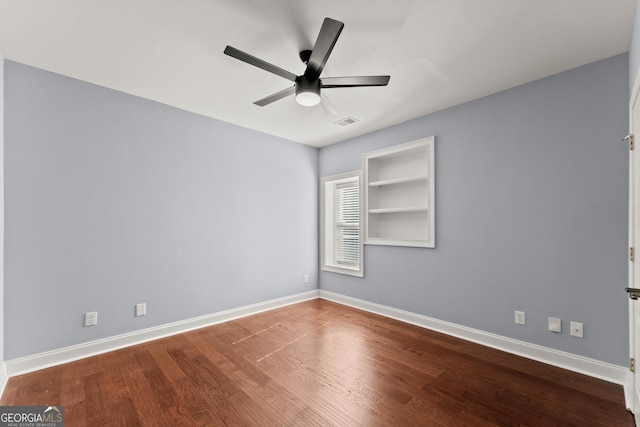 1348 Ewing Creek Dr, Dacula, GA 30019 - empty room featuring ceiling fan, wood finished floors, and built in shelves