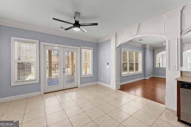 1348 Ewing Creek Dr, Dacula, GA 30019 - unfurnished room with light tile patterned floors, ceiling fan, crown molding, healthy amount of natural light, and arched walkways