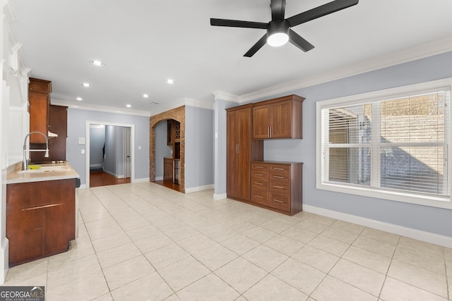 1348 Ewing Creek Dr, Dacula, GA 30019 - kitchen featuring crown molding, arched walkways, ceiling fan, recessed lighting, and light tile patterned flooring