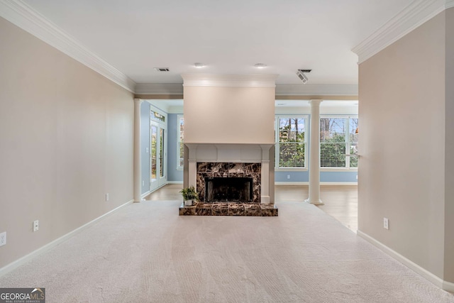 unfurnished living room featuring ornamental molding, visible vents, decorative columns, and a premium fireplace