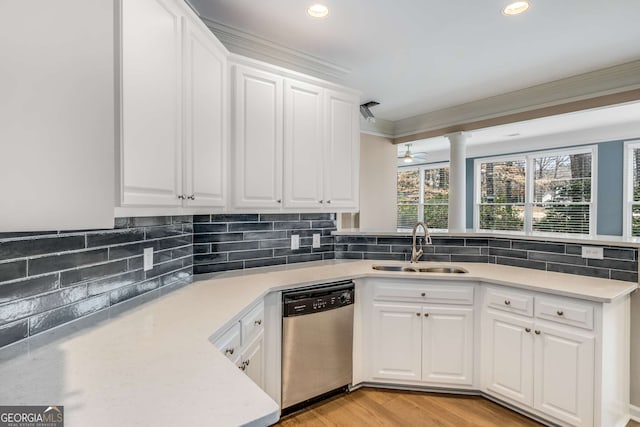 kitchen featuring decorative backsplash, dishwasher, a peninsula, and a sink