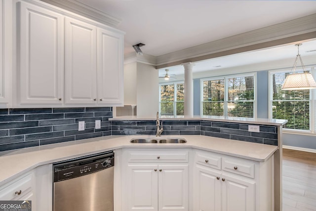 kitchen featuring backsplash, ornamental molding, a sink, dishwasher, and a peninsula