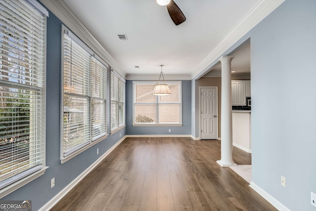 interior space with visible vents, dark wood-style flooring, decorative columns, and crown molding