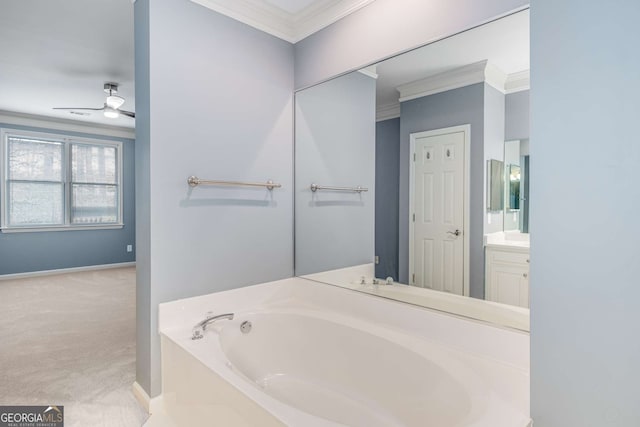 full bathroom with baseboards, vanity, a bath, and crown molding