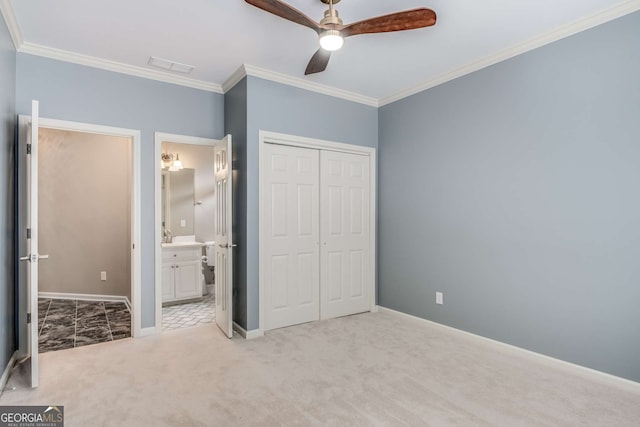 unfurnished bedroom with baseboards, visible vents, crown molding, carpet floors, and a closet