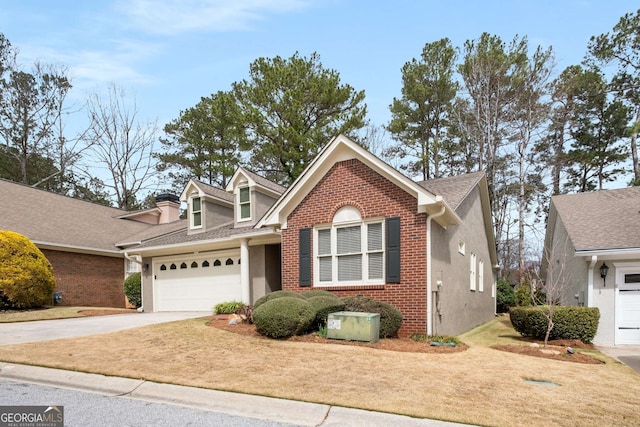 view of front of home featuring brick siding, driveway, an attached garage, and stucco siding