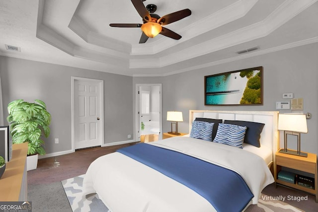 bedroom featuring baseboards, visible vents, a raised ceiling, and ornamental molding