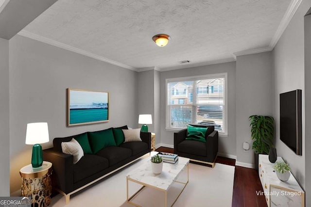 living room with a textured ceiling, ornamental molding, wood finished floors, and baseboards