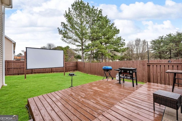 deck with a fenced backyard and a yard