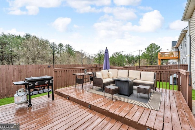 wooden deck with outdoor lounge area and a fenced backyard